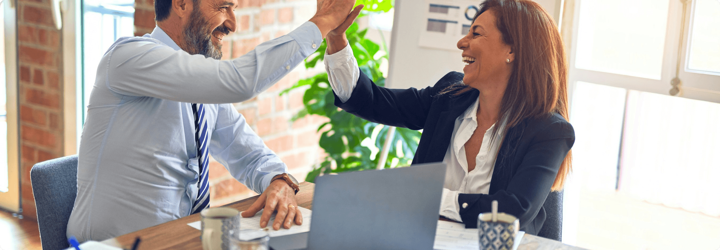 High-five between business professionals